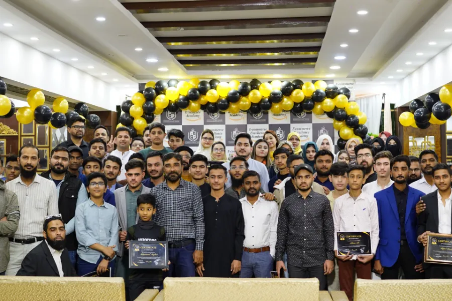 Group photo of students and staff at an E-Commerce Excellence Academy graduation event in Karachi