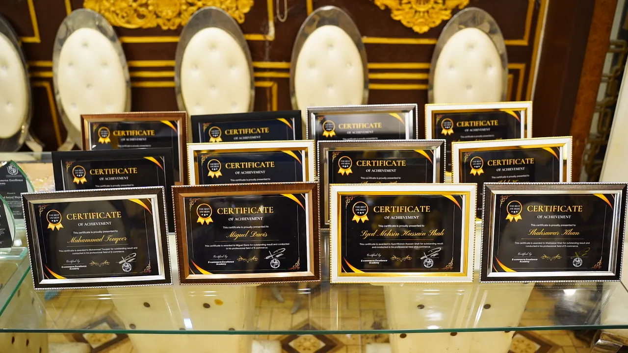 Framed Certificates of Achievement displayed for E-Commerce Excellence Academy graduates